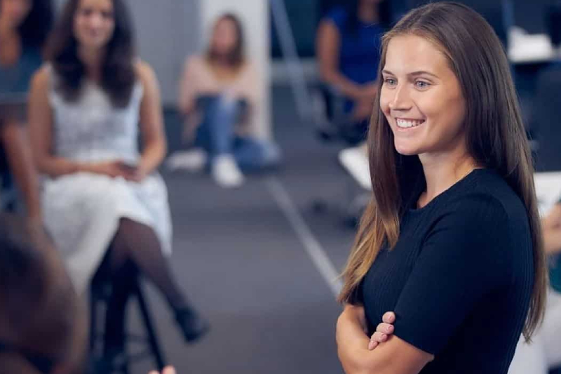 A group of working women in an office are in business communication.